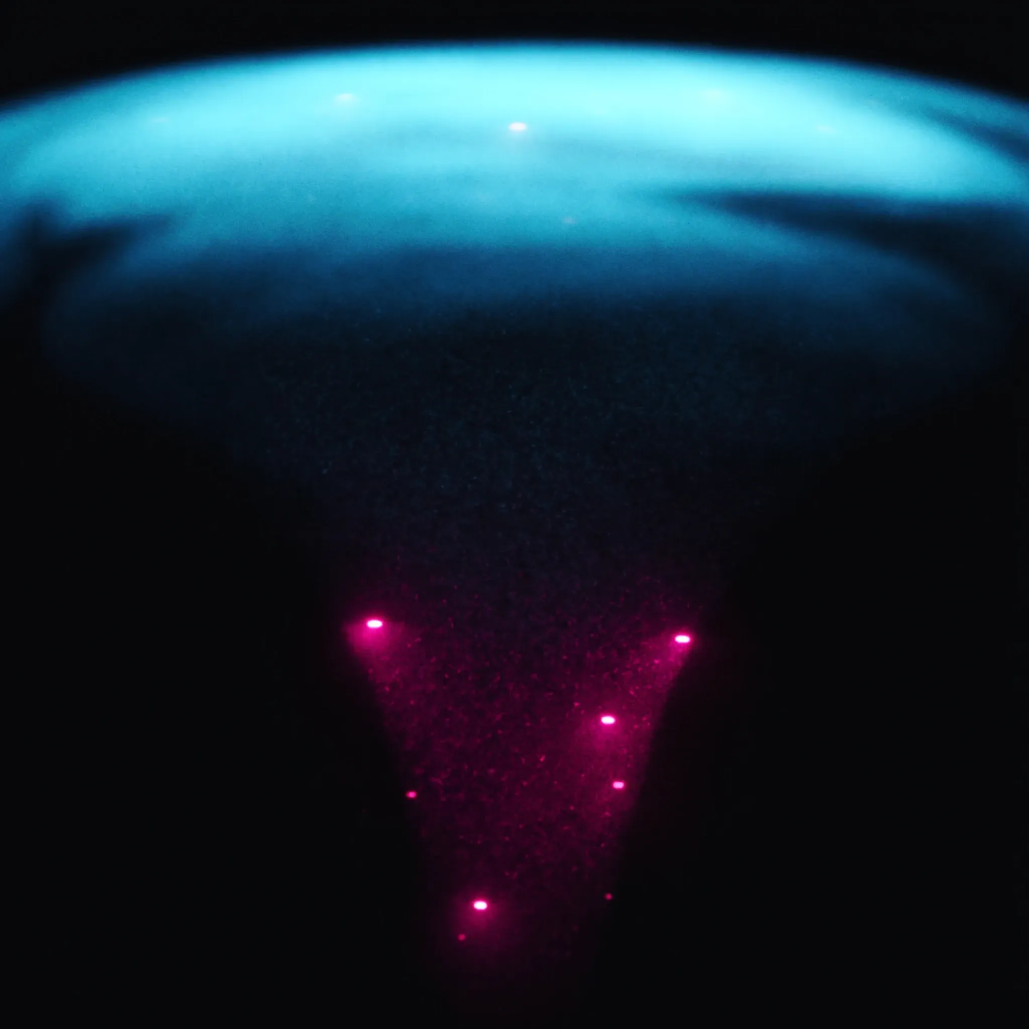 A funnel of light filtering many dim particles into a few bright ones
