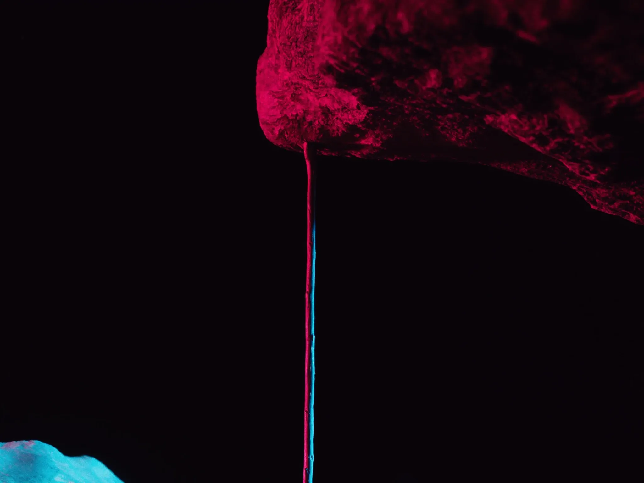 One thin wooden support straining under a heavy stone slab, dramatic side light on black