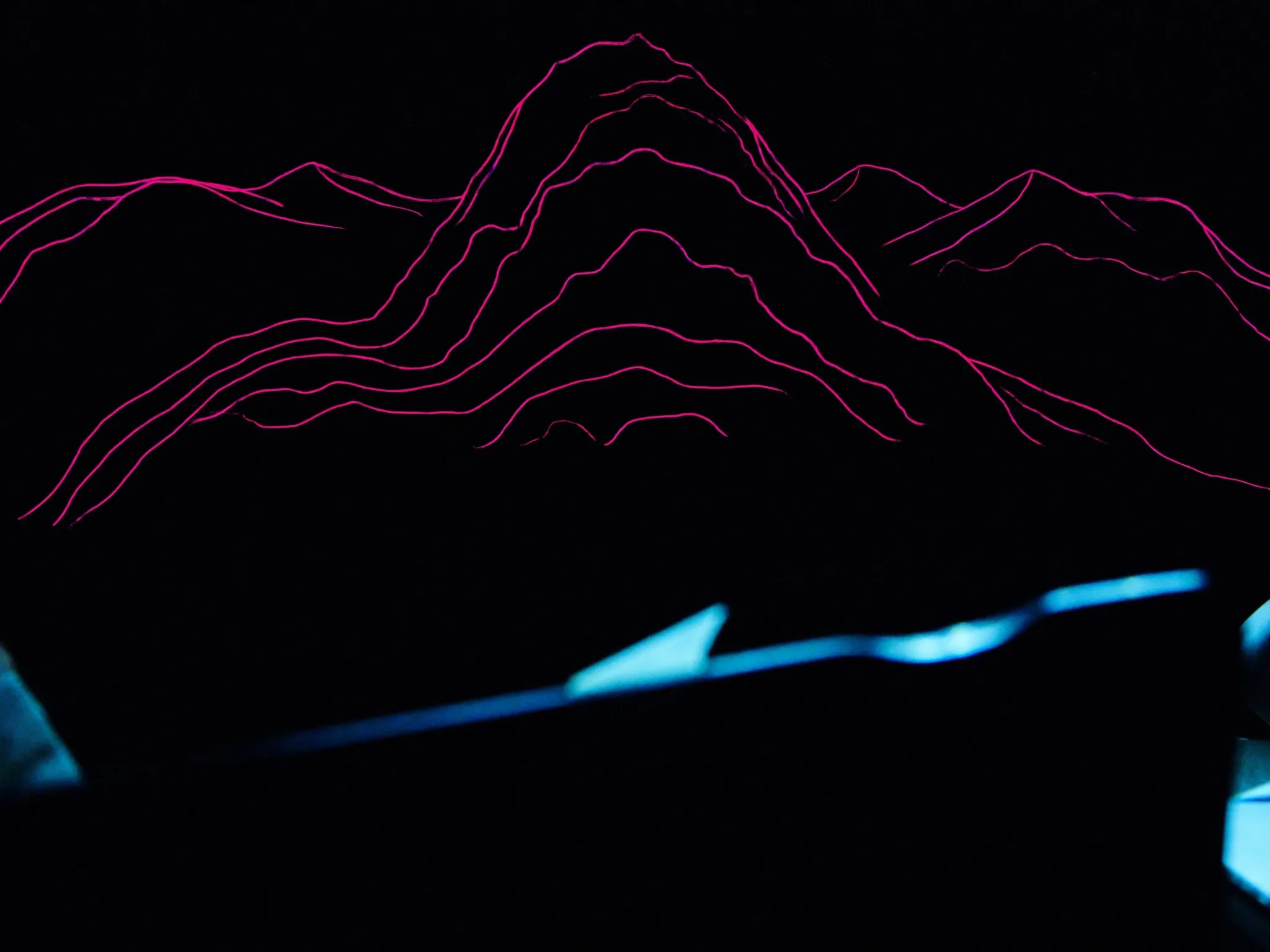 Contour lines of a mountain drawn in thin glowing lines, rising toward a peak, topographic and minimal