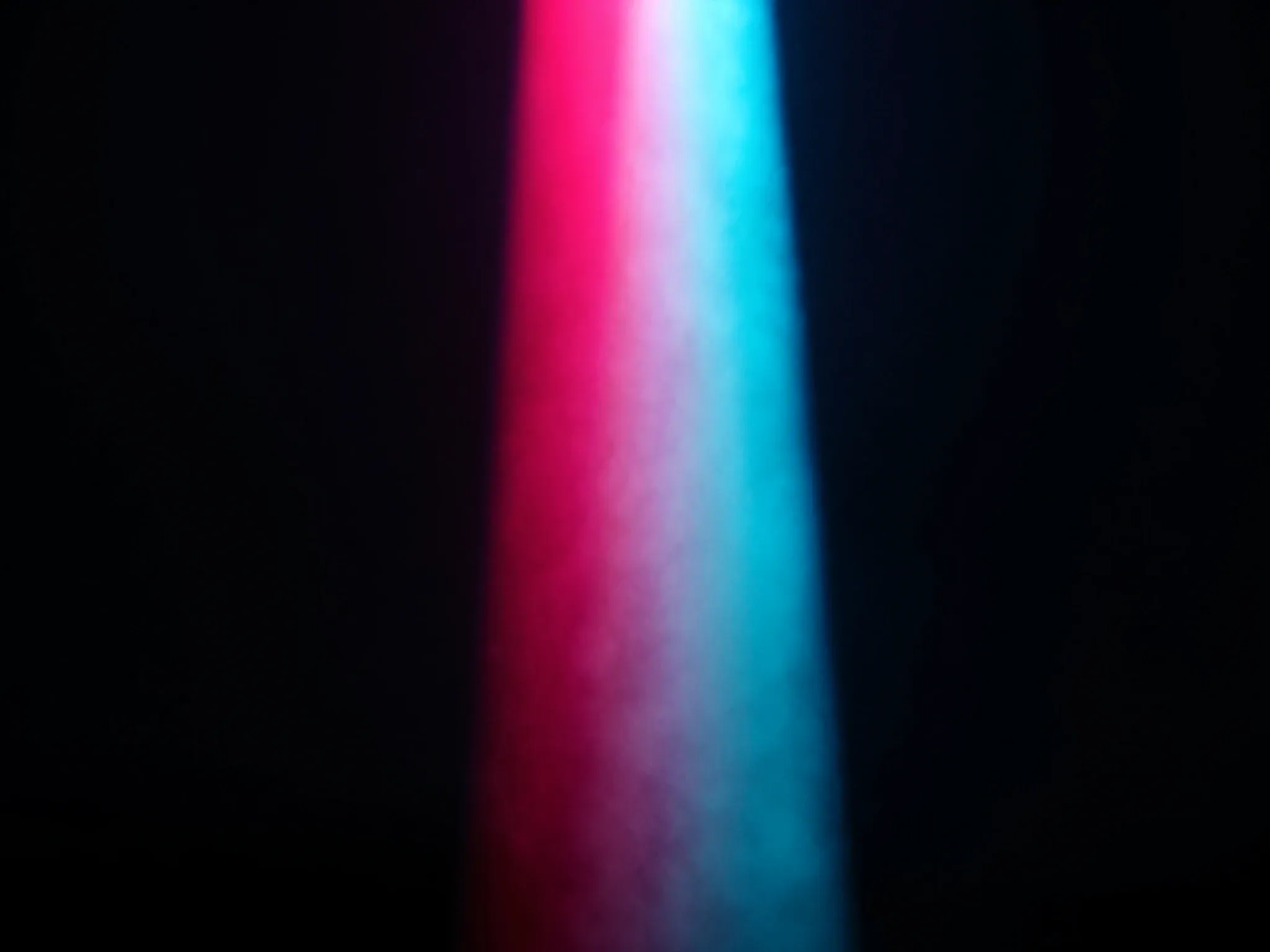 A single shaft of light cutting through dark fog in a perfectly straight line, catching drifting dust in pink and cyan