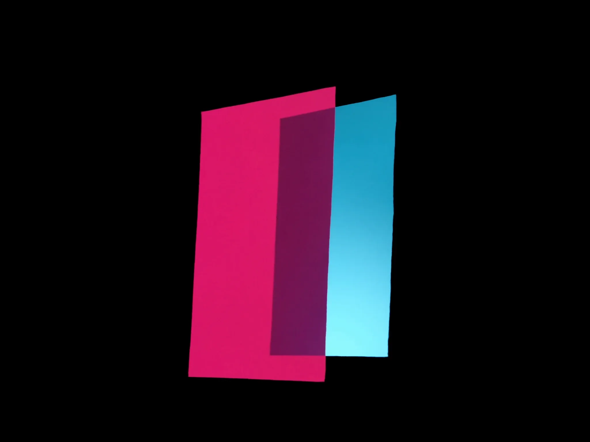 Overlapping sheets of translucent coloured glass, pink and cyan light passing through where they meet, against black